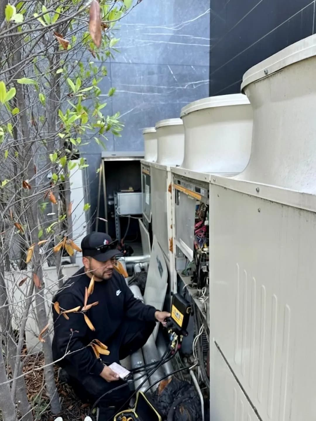 Technician servicing commercial cooling equipment