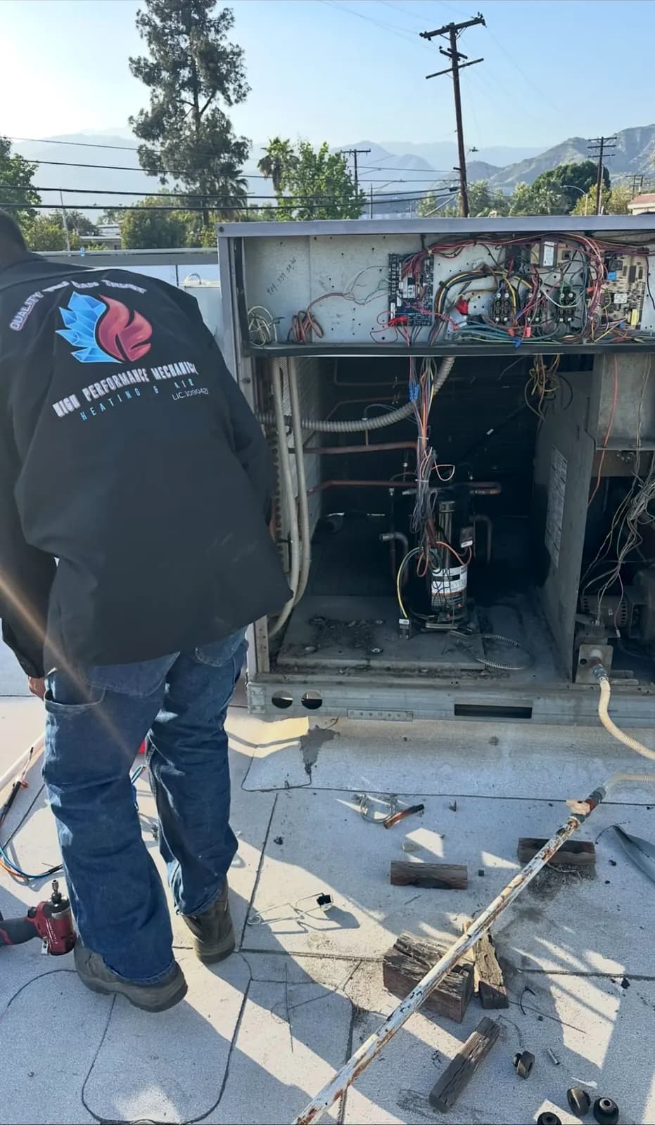 Technician repairing the wiring of an open package unit