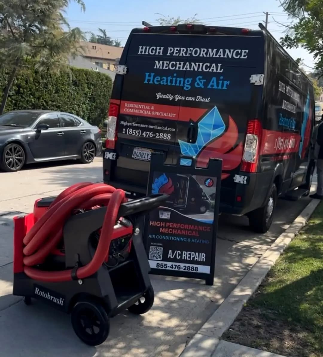 Service van with duct cleaning equipment on the sidewalk