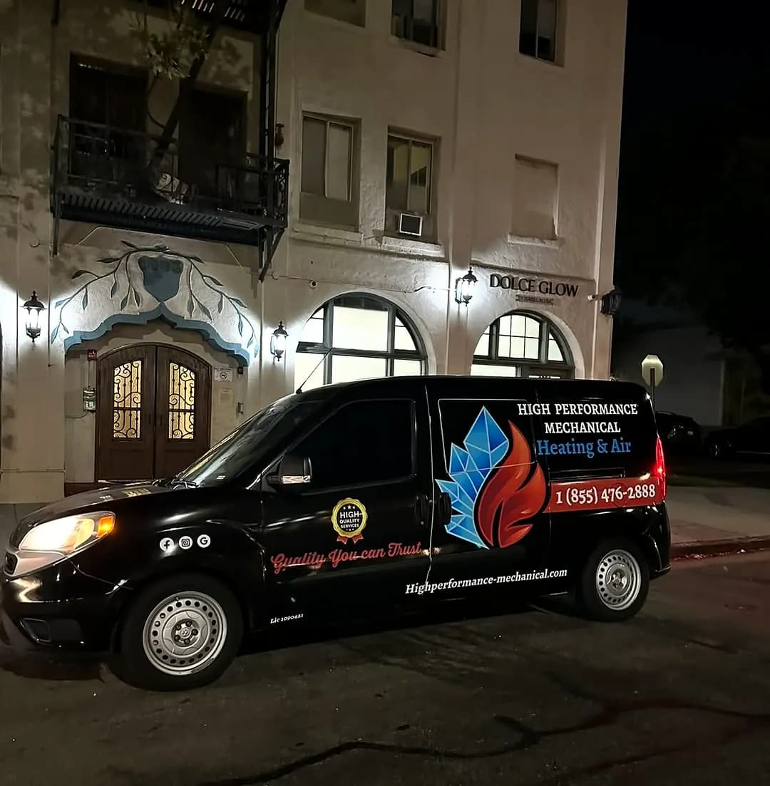 Service van parked outside a historic building at night