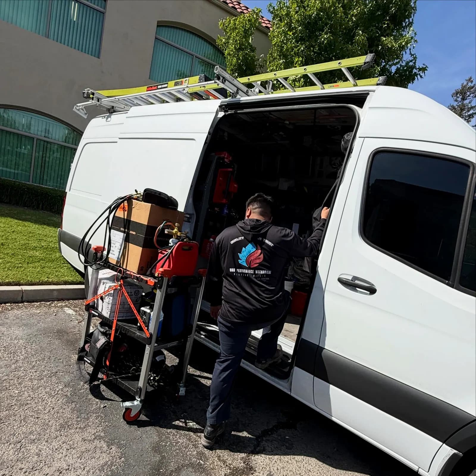 Technician loading tools and equipment into a service van
